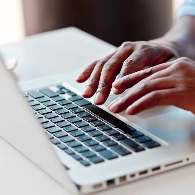 Closeup of a man's hands on laptop