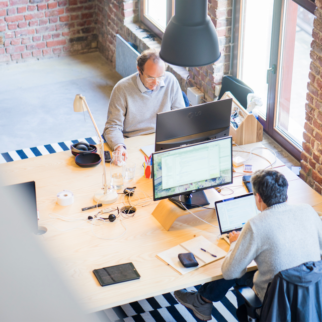 Overhead shot of men working in an office