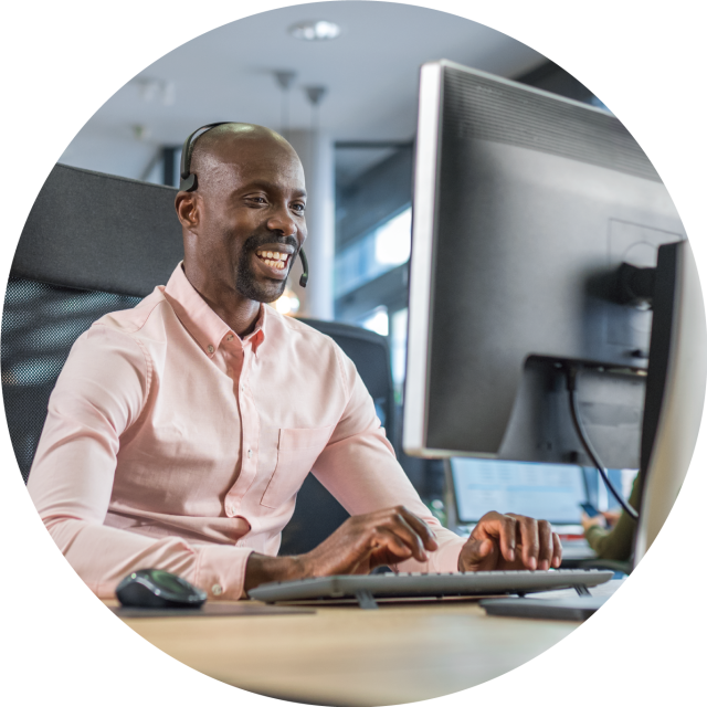 Man discussing benefits of Conga Max while working on laptop