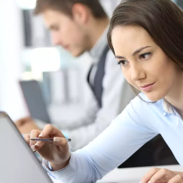 Woman looking closely at laptop screen