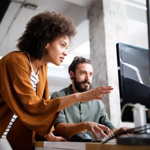 Woman and man looking at a computer screen together