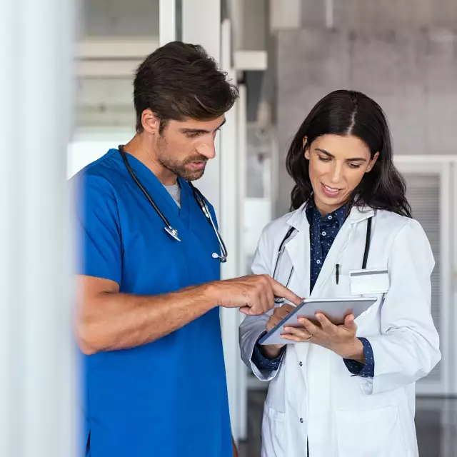 Two nurses looking at a tablet