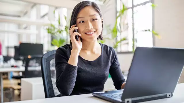 Woman smiling on cell phone