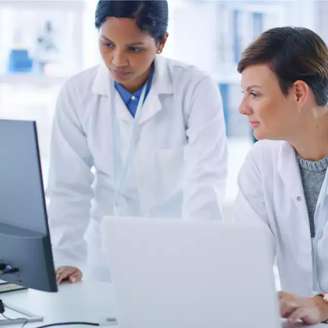 Lab technicians using Conga products on laptop