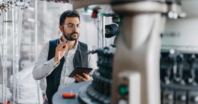 Man looking at manufacturing machinery