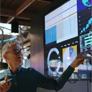 Man pointing to a screen with AI charts