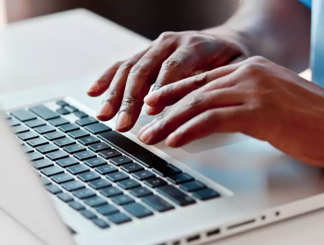 Close up of hands typing
