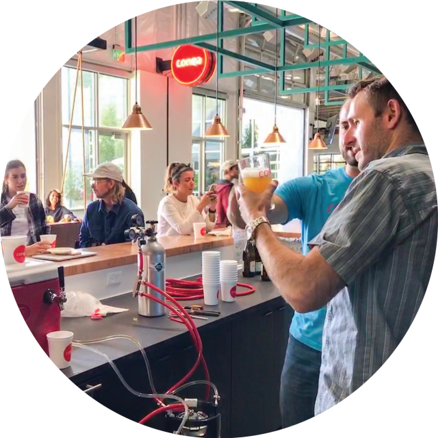 Conga employees drinking beer at the office bar