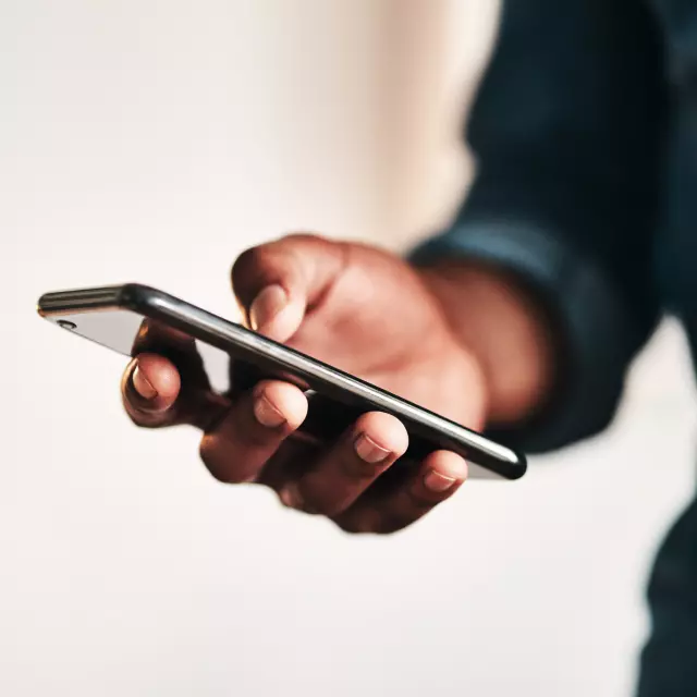 Closeup of a man's hand on cell phone