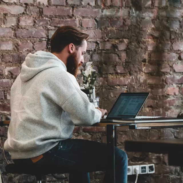 Man working on laptop from coffee shop