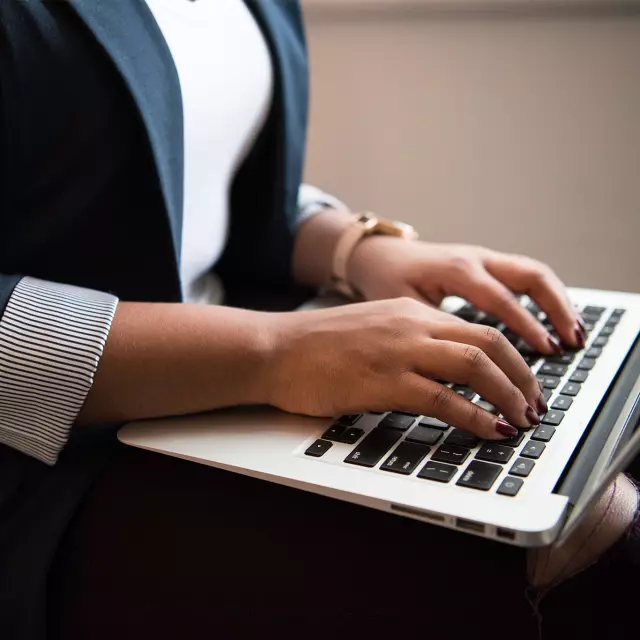 Closeup of woman working on laptop