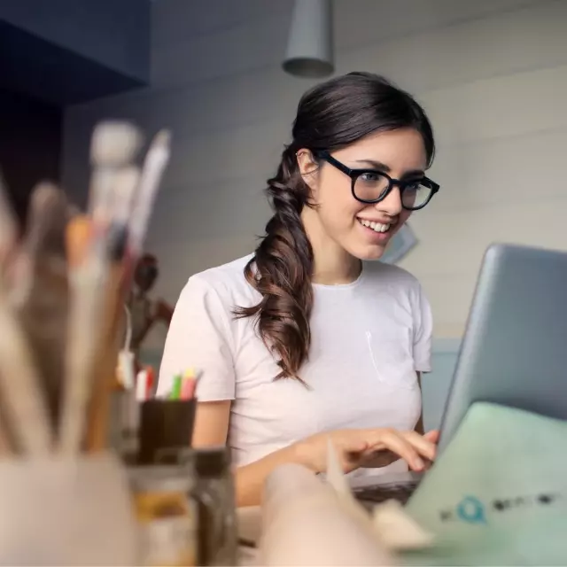 Woman smiling looking at laptop