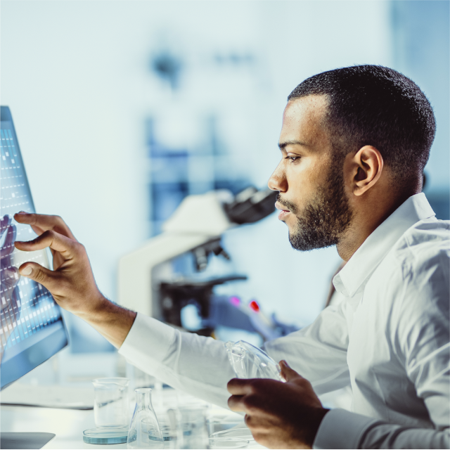 Man using touchscreen laptop in lab