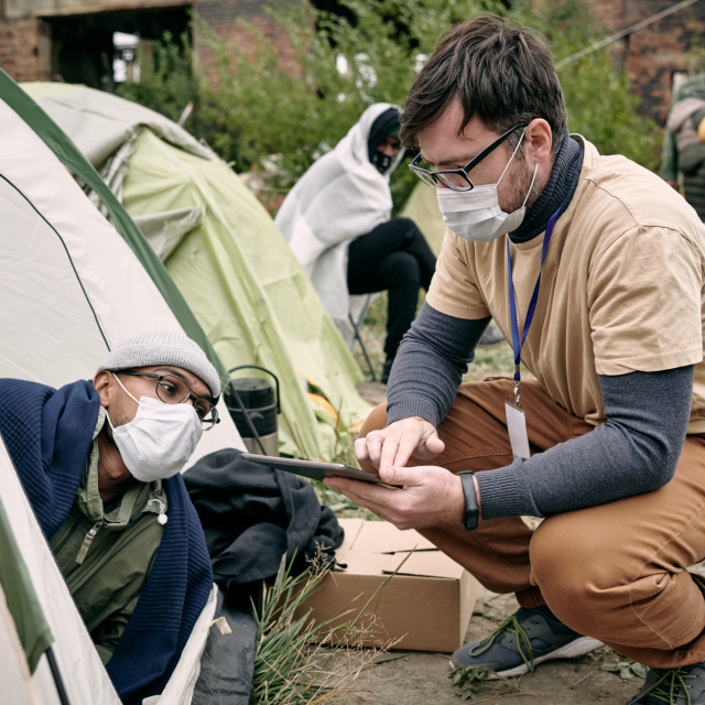 Volunteer helping homeless people