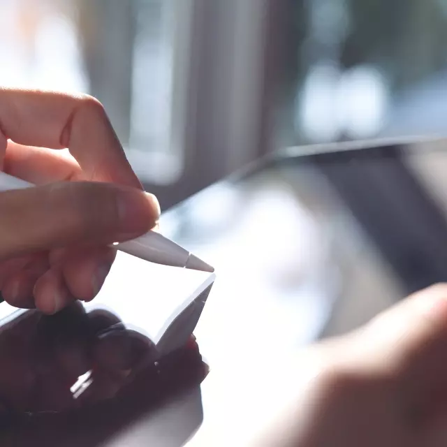 Person signing a contract on a tablet