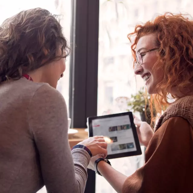 Two woman looking at a tablet