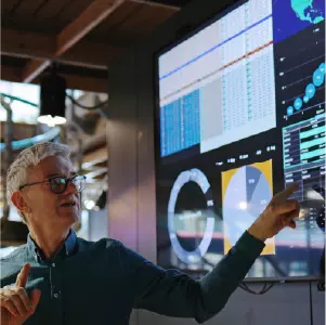 Man pointing to a screen with AI charts