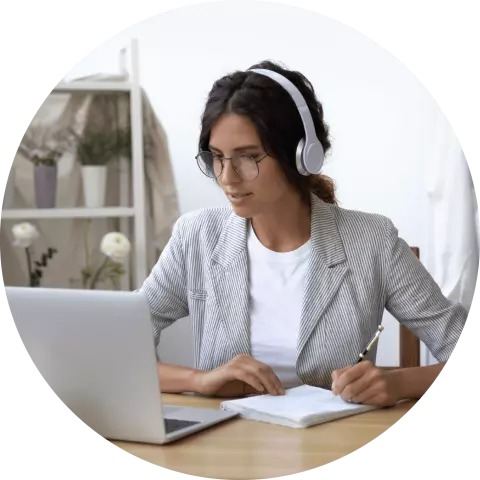 Woman wearing headphones staring at laptop